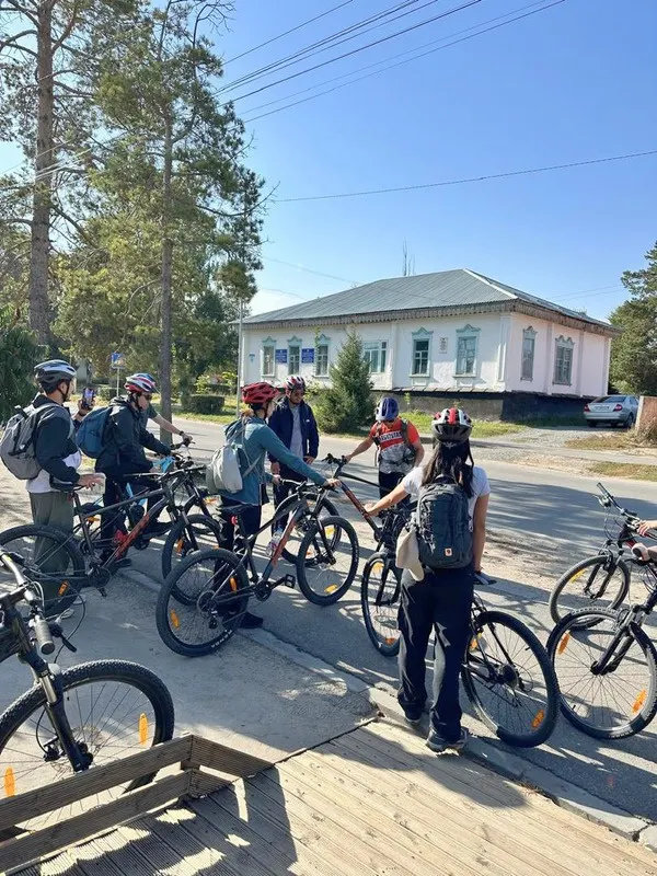 A group of riders on a street in old Karakol