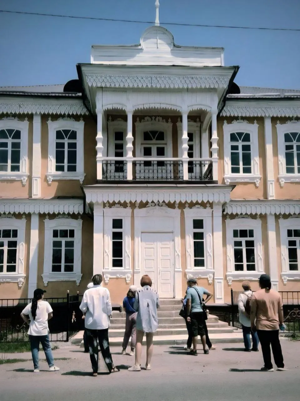 A tour group at a carved wooden house in old Karakol