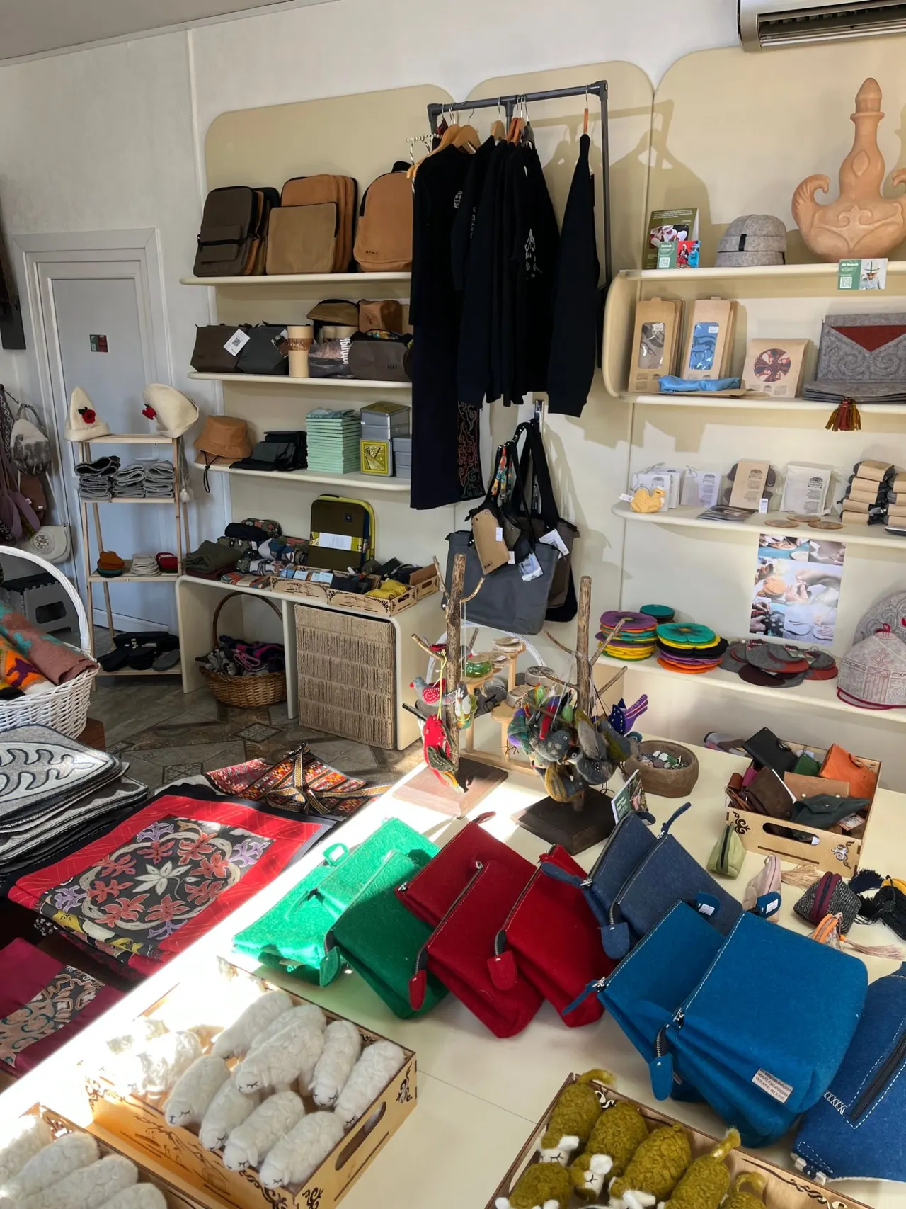 A sunny table of felt goods inside EthnoMir Point